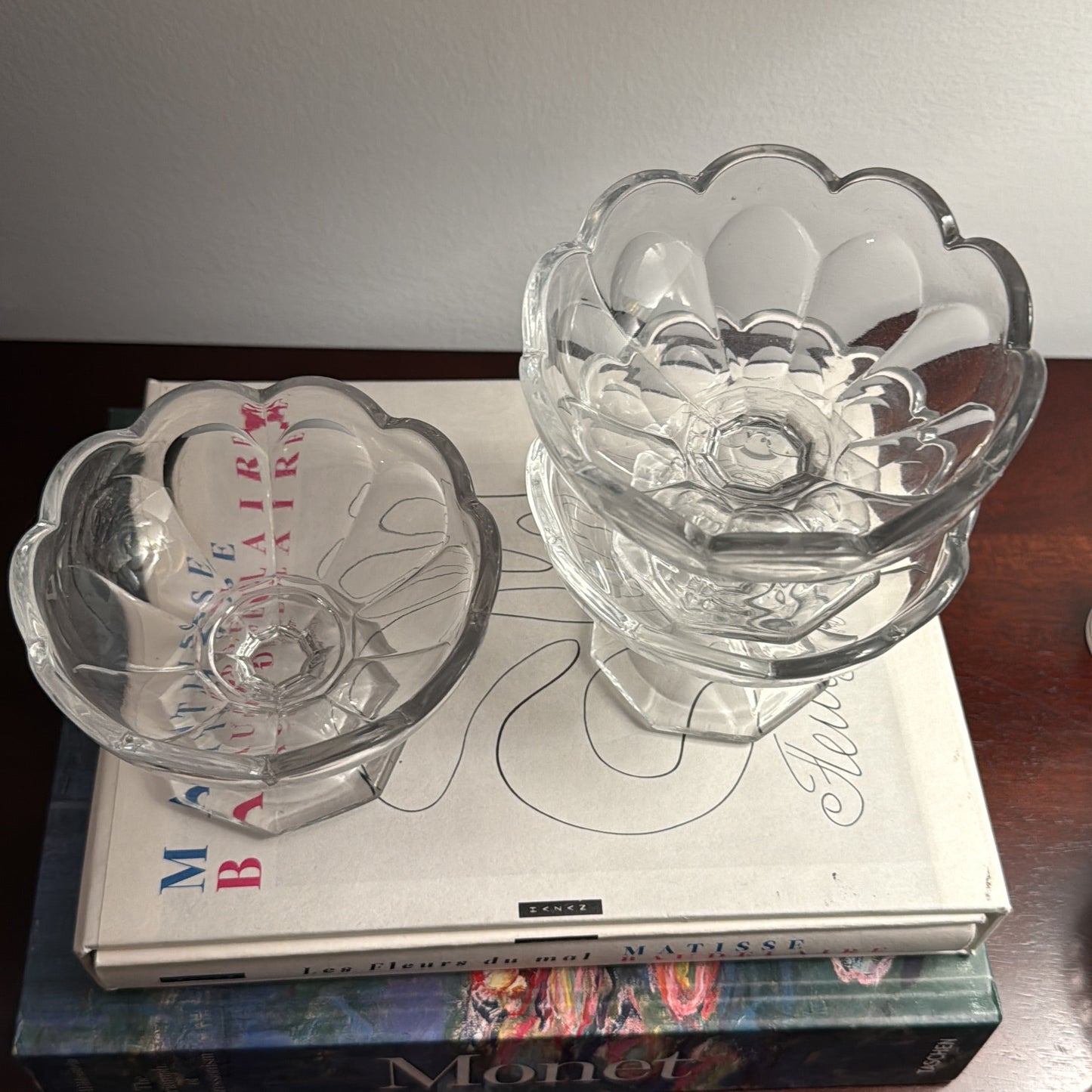 Clear glass candle holders on top of books with a blurred background